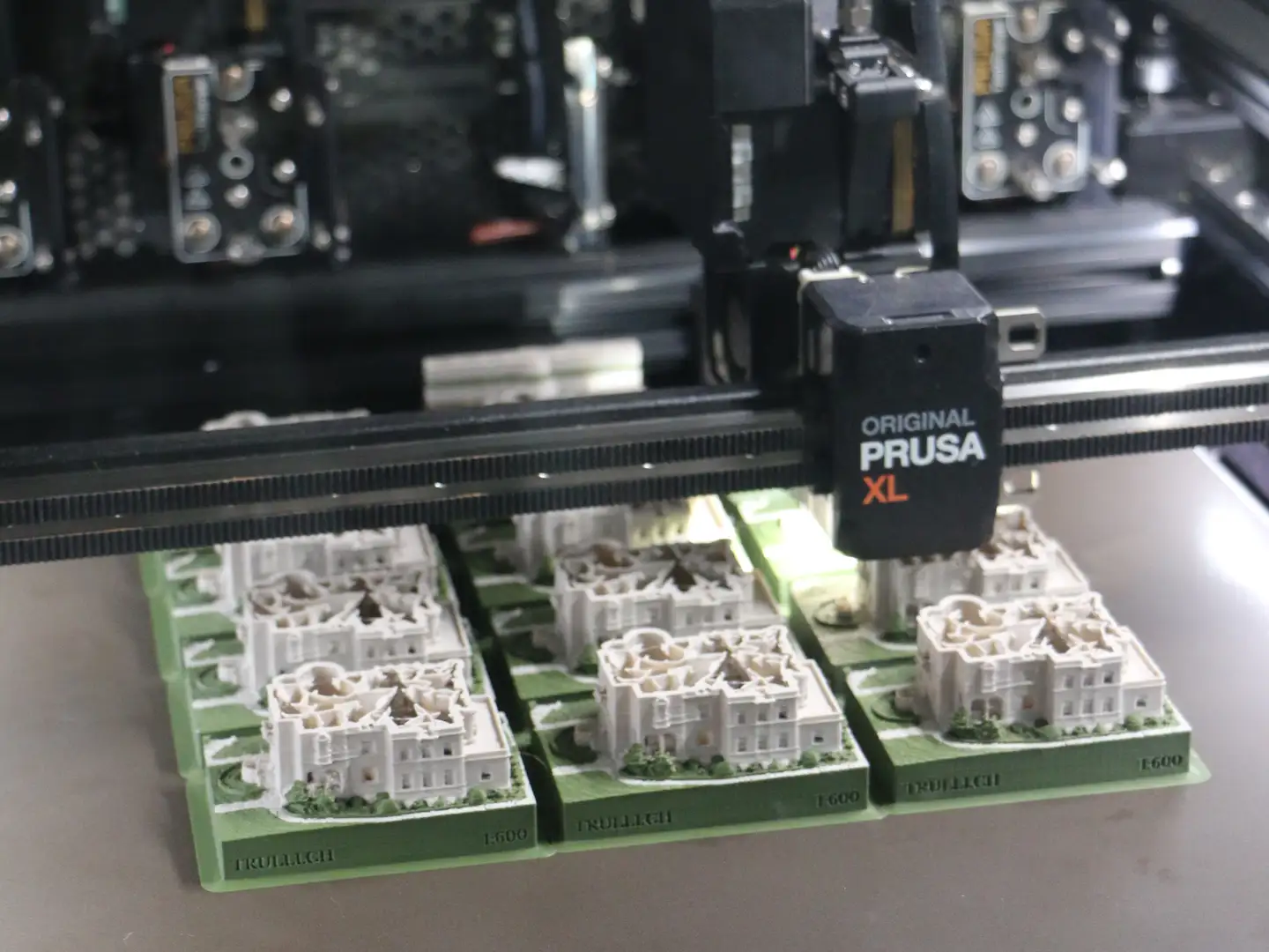 Druckbett des Prusa XL mit mehreren Burgmodellen im Massstab 1:600, graviert mit TRULLI.CH